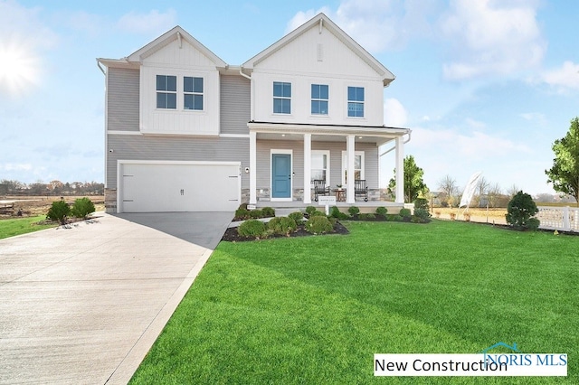 view of front of home featuring a front lawn, covered porch, and a garage