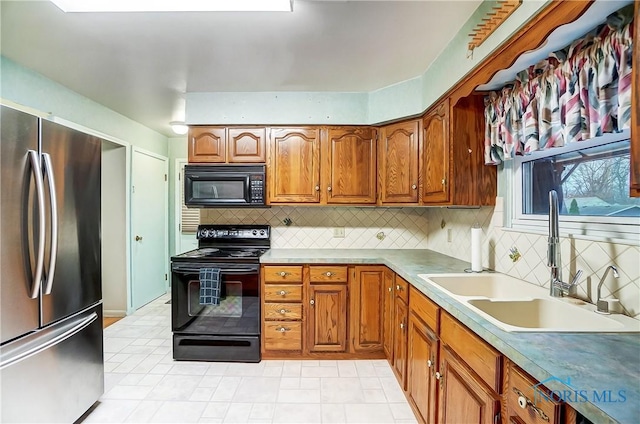 kitchen with black appliances, sink, and tasteful backsplash