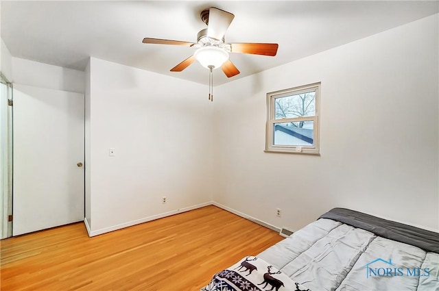 bedroom featuring ceiling fan and hardwood / wood-style floors