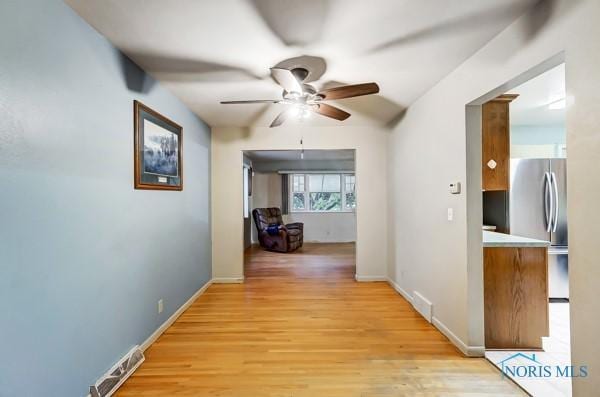 corridor with light hardwood / wood-style flooring