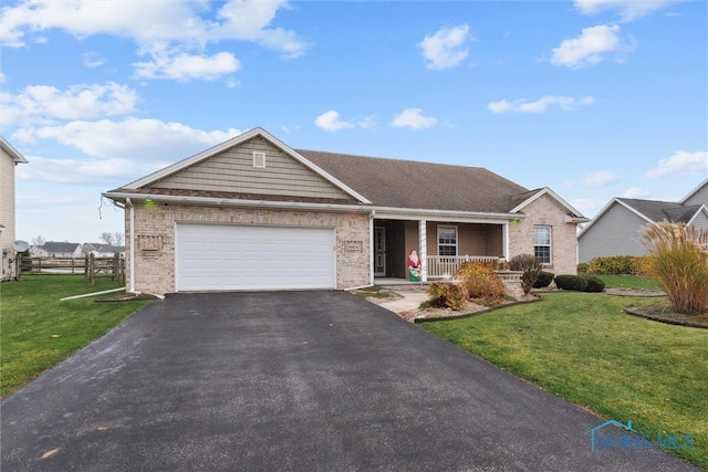 single story home featuring a front lawn, covered porch, and a garage