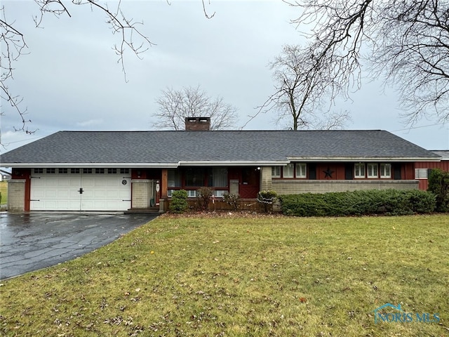 single story home featuring a garage and a front yard