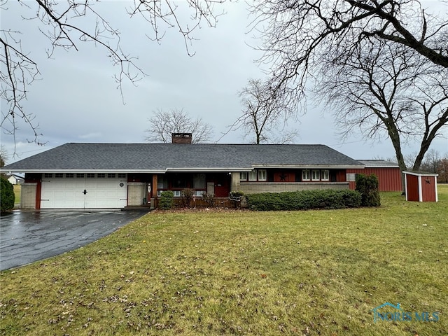 single story home with a front lawn, a shed, and a garage