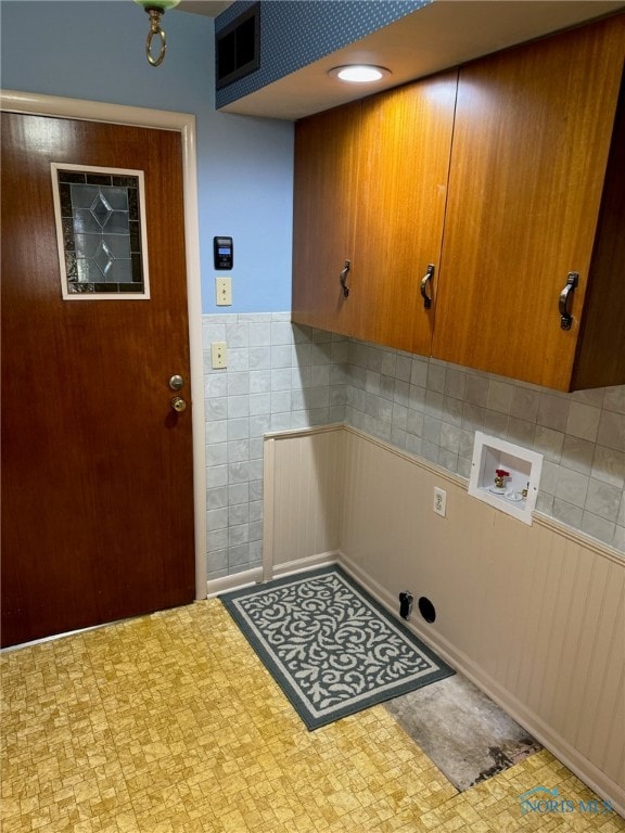 laundry area with hookup for a washing machine and cabinets