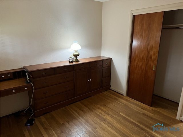 unfurnished bedroom with hardwood / wood-style floors and a closet