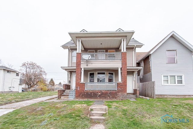 view of front of property with a porch, a balcony, and a front yard