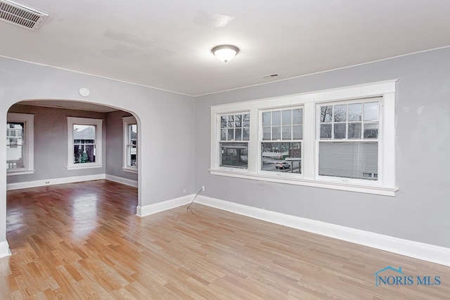 unfurnished room featuring plenty of natural light and light hardwood / wood-style floors