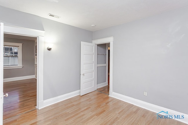 spare room with wood-type flooring and a textured ceiling