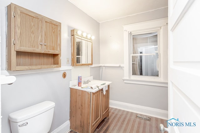 bathroom featuring hardwood / wood-style flooring, vanity, and toilet