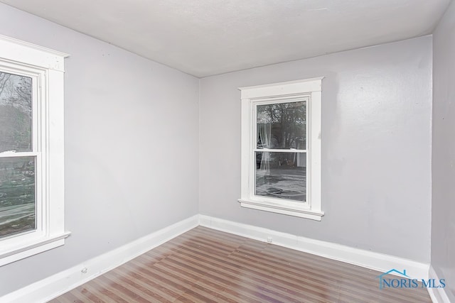 unfurnished room featuring hardwood / wood-style floors