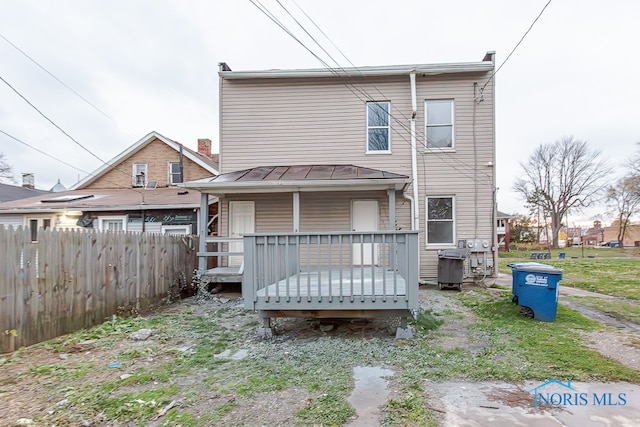 back of house with a wooden deck