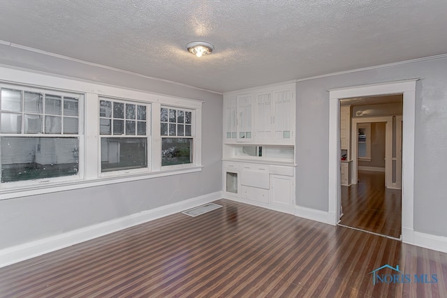 unfurnished living room featuring a textured ceiling and dark wood-type flooring