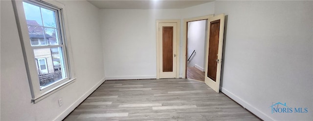 unfurnished room with light hardwood / wood-style flooring