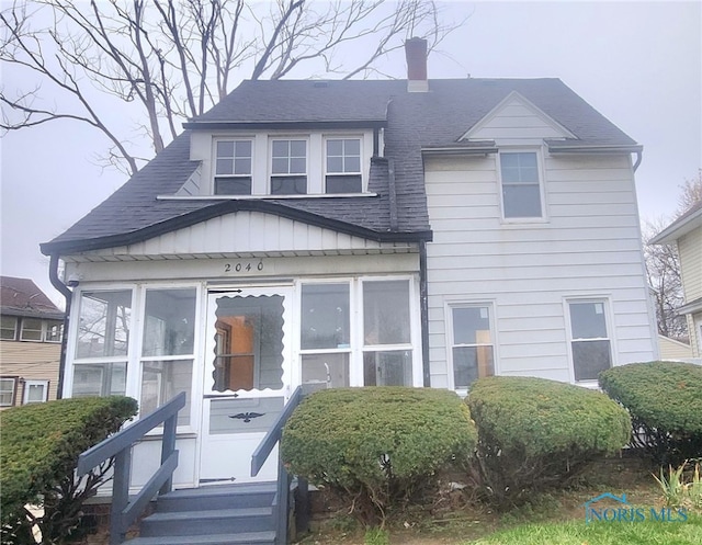 view of front of home featuring a sunroom