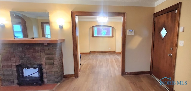 corridor featuring crown molding and hardwood / wood-style floors