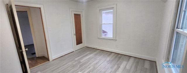 unfurnished room featuring light hardwood / wood-style floors and a healthy amount of sunlight