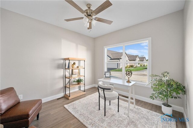 home office featuring ceiling fan and light hardwood / wood-style floors