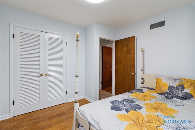 bedroom featuring hardwood / wood-style floors and a closet