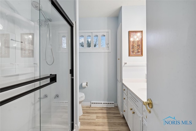 bathroom with vanity, hardwood / wood-style flooring, toilet, and walk in shower