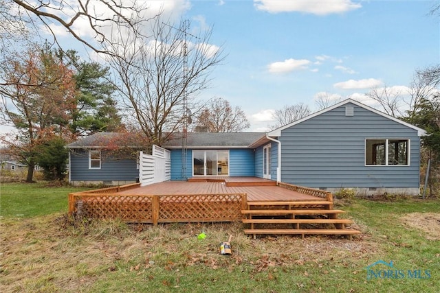 back of property with a yard and a wooden deck