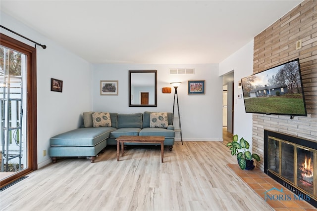 living room featuring a fireplace and light hardwood / wood-style flooring