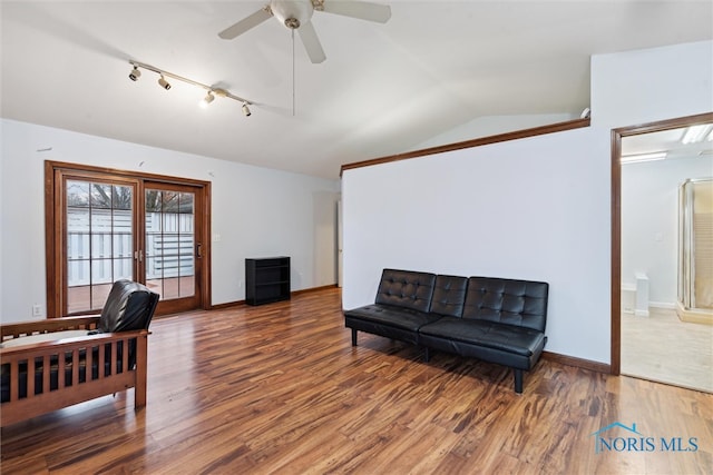 living room featuring ceiling fan, track lighting, dark wood-type flooring, and lofted ceiling