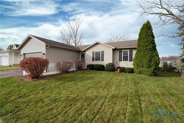 single story home with a garage and a front lawn