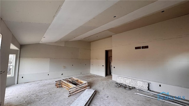 spare room featuring visible vents and vaulted ceiling