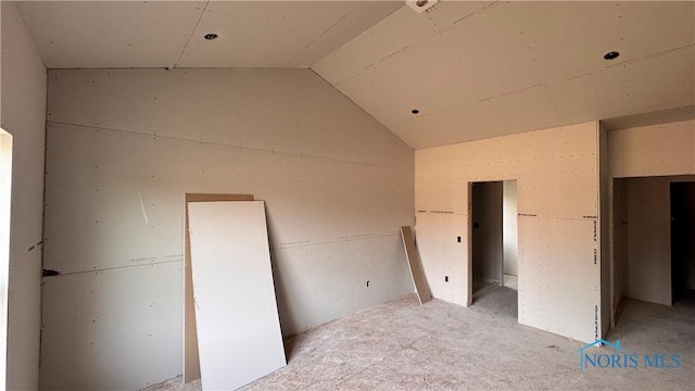 unfurnished bedroom featuring lofted ceiling