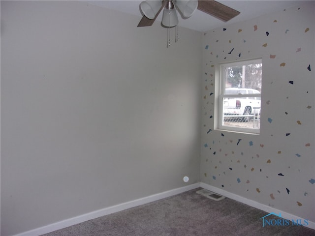 carpeted spare room with ceiling fan