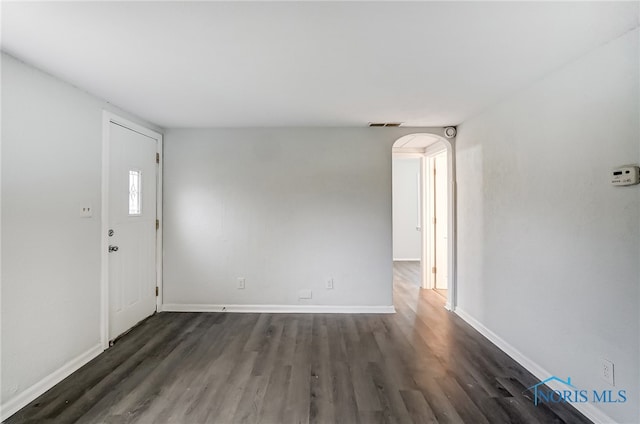 spare room featuring dark hardwood / wood-style flooring