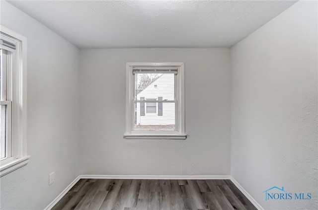 empty room with dark wood-type flooring