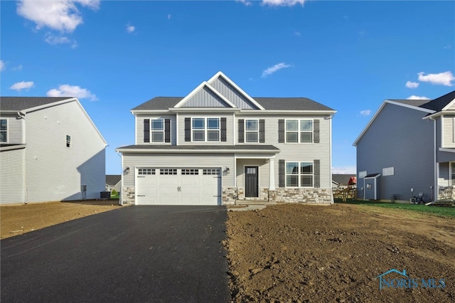 view of front of home featuring a garage and central AC unit