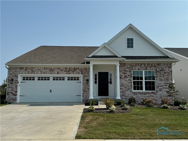 view of front facade featuring a front yard and a garage