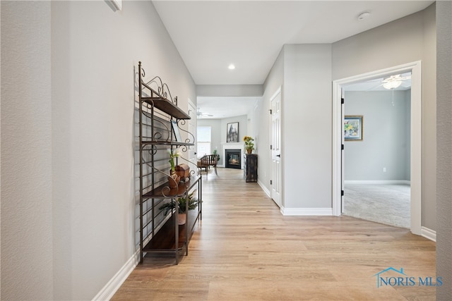 corridor with light hardwood / wood-style floors