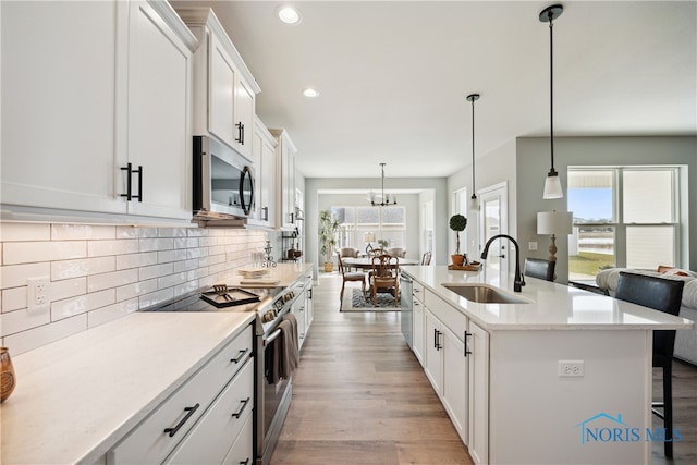 3343 Moonlit Pass, Monclova, OH 43542 - kitchen featuring white cabinetry, sink, pendant lighting, and appliances with stainless steel finishes