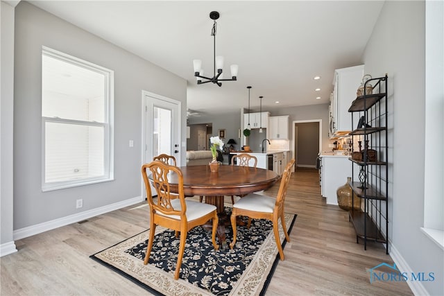 3343 Moonlit Pass, Monclova, OH 43542 - dining area with light hardwood / wood-style flooring, a chandelier, and sink