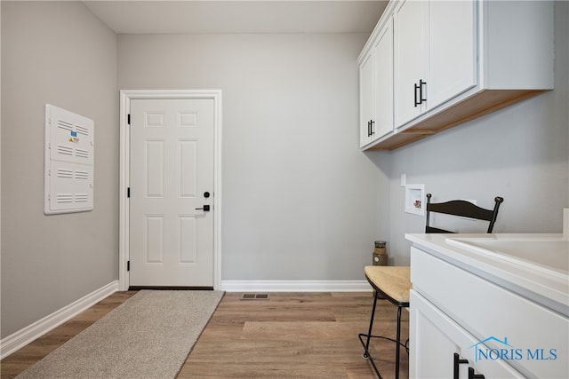 3343 Moonlit Pass, Monclova, OH 43542 - laundry area with cabinets, hookup for a washing machine, and light wood-type flooring