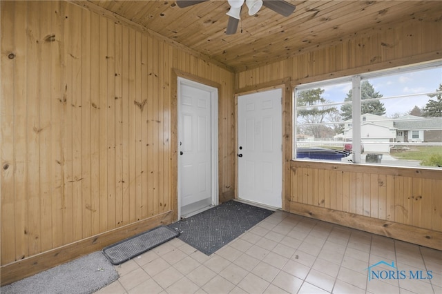 unfurnished sunroom featuring ceiling fan and wooden ceiling