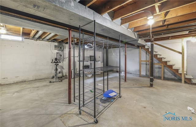 basement with electric panel and washer / clothes dryer