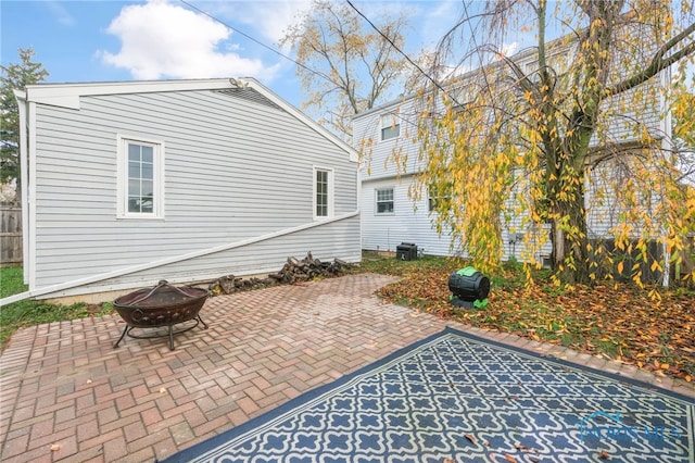 view of patio featuring cooling unit and a fire pit