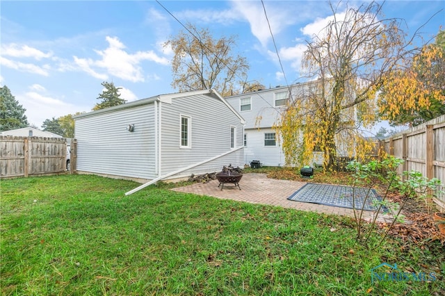 rear view of house featuring a patio, a fire pit, and a lawn