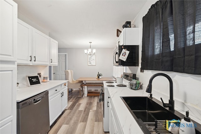 kitchen with pendant lighting, white cabinets, white electric range, sink, and stainless steel dishwasher