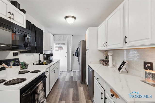 kitchen with light stone countertops, stainless steel appliances, sink, wood-type flooring, and white cabinetry