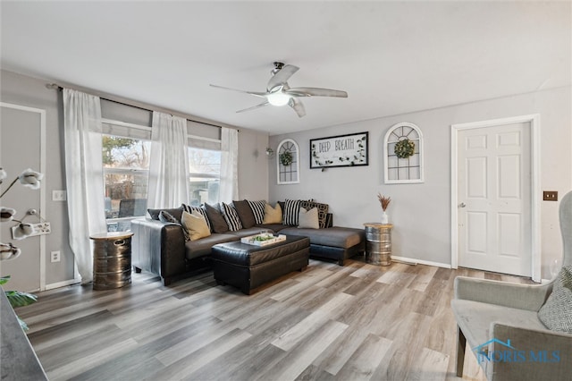 living room featuring hardwood / wood-style flooring and ceiling fan