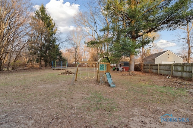 view of yard featuring a trampoline and a playground