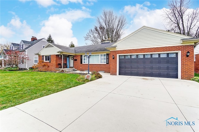 view of front of property with a front yard and a garage