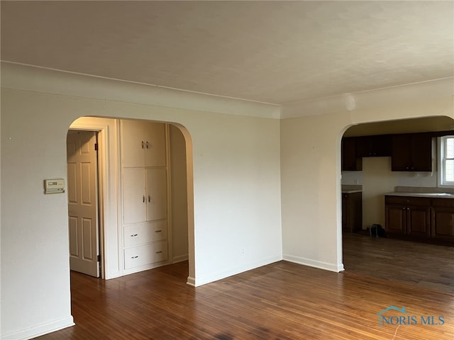 spare room with dark wood-type flooring