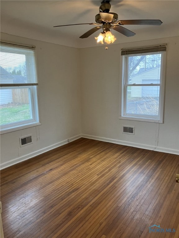 unfurnished room featuring ceiling fan and dark hardwood / wood-style floors