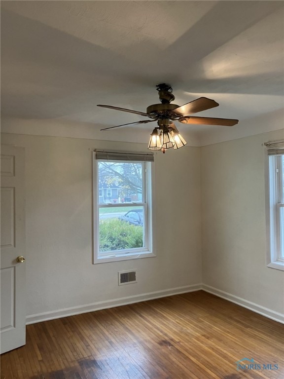 unfurnished room with hardwood / wood-style floors and ceiling fan